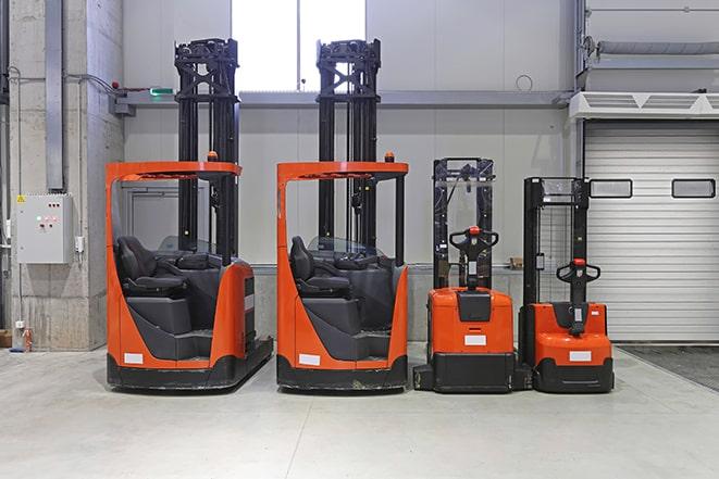 four forklifts in a warehouse